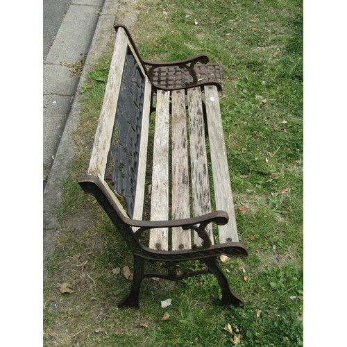 1183 - A child's size weathered garden bench with cast iron panelled back and end supports, 83 cm long (af)