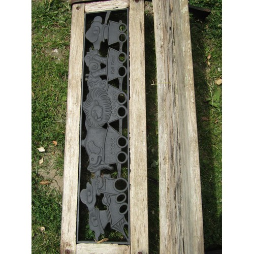 1183 - A child's size weathered garden bench with cast iron panelled back and end supports, 83 cm long (af)