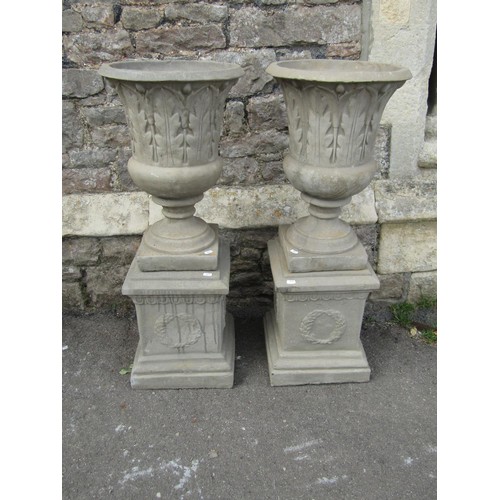 1189 - A pair of cast composition stone trumpet shaped garden urns with flared rims and leaf moulded detail... 