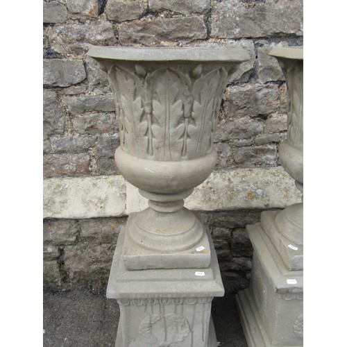 1189 - A pair of cast composition stone trumpet shaped garden urns with flared rims and leaf moulded detail... 