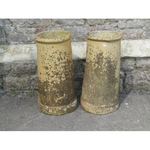 1190 - A pair of weathered buff coloured cylindrical chimney pots, 60 cm high