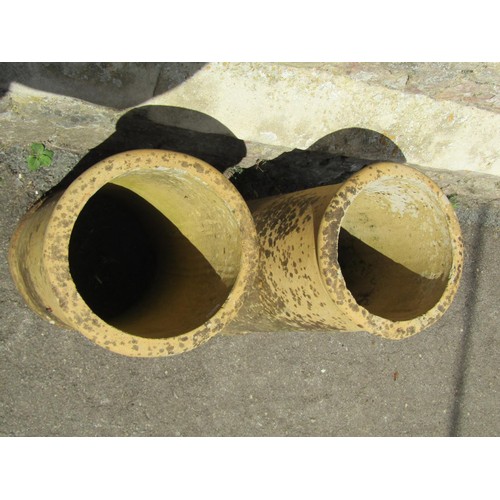 1190 - A pair of weathered buff coloured cylindrical chimney pots, 60 cm high