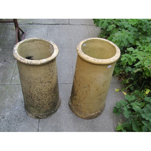 1190 - A pair of weathered buff coloured cylindrical chimney pots, 60 cm high