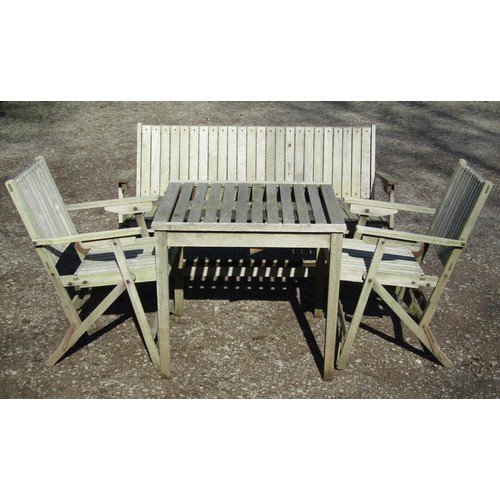 1154 - A weathered (silvered) teak garden suite comprising a folding bench with slatted seat and back 141 c... 