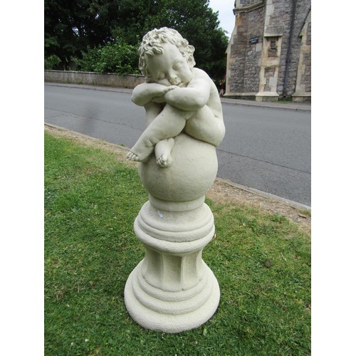 1200 - A good quality contemporary cast composition stone garden ornament in the form of a sleeping cross l... 