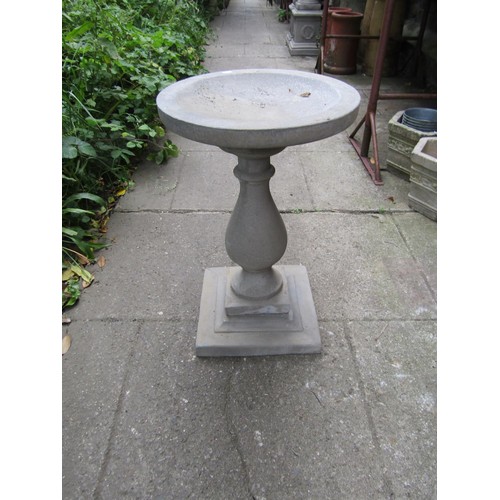 1201 - A cast composition stone three sectional bird bath with circular top raised on a baluster pedestal a... 