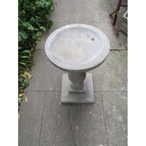 1201 - A cast composition stone three sectional bird bath with circular top raised on a baluster pedestal a... 