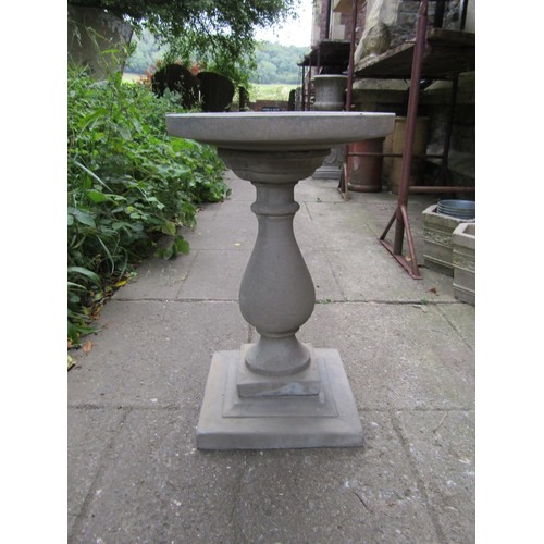 1201 - A cast composition stone three sectional bird bath with circular top raised on a baluster pedestal a... 