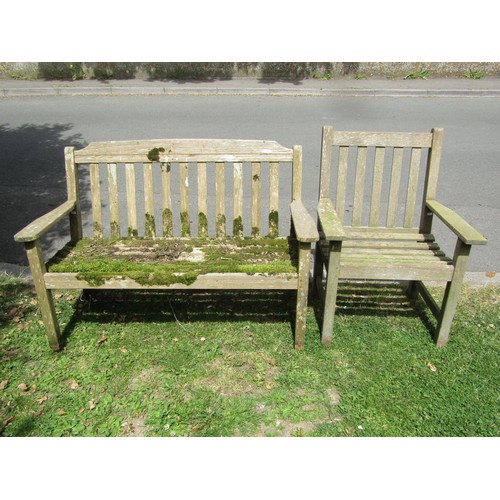 1202 - A weathered Lister teak two seat garden bench with slatted seat and back, 128 cm long together with ... 