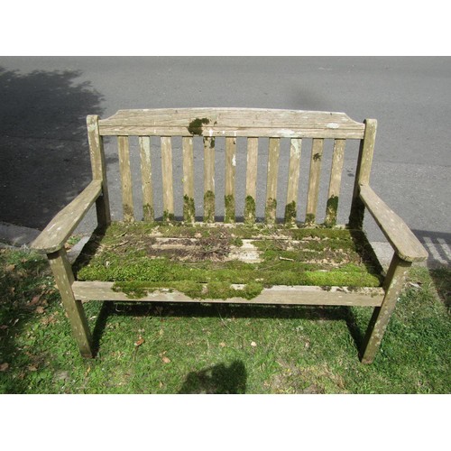 1202 - A weathered Lister teak two seat garden bench with slatted seat and back, 128 cm long together with ... 