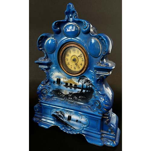 9 - A late 19th/early 20th century ceramic clock garniture comprising mantle clock within a rococo style... 