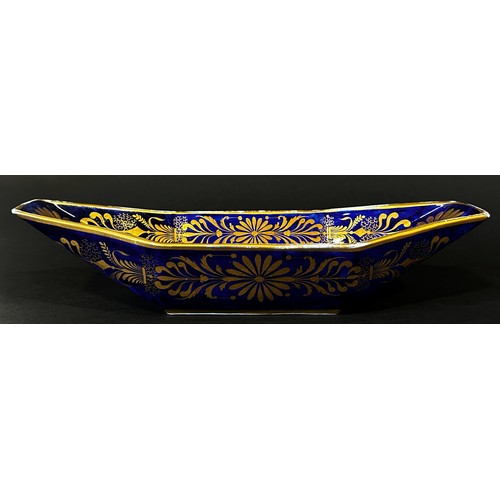 126 - A 19th century continental porcelain bread dish of boat form with cobalt ground, decorated with gilt... 