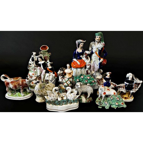 23 - A group of mixed Staffordshire figures, flatbacks to include spaniels, lions, figure groups, etc (18... 