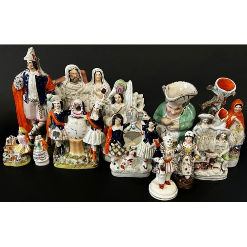 32 - A mixed collection of Staffordshire pottery figure groups to include fob watch, case examples, other... 