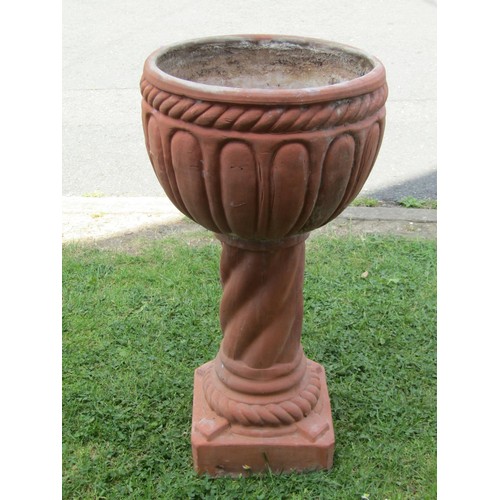 1204 - A weathered contemporary terracotta planter with circular bowl raised on a cylindrical pedestal and ... 