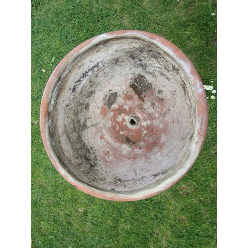 1204 - A weathered contemporary terracotta planter with circular bowl raised on a cylindrical pedestal and ... 