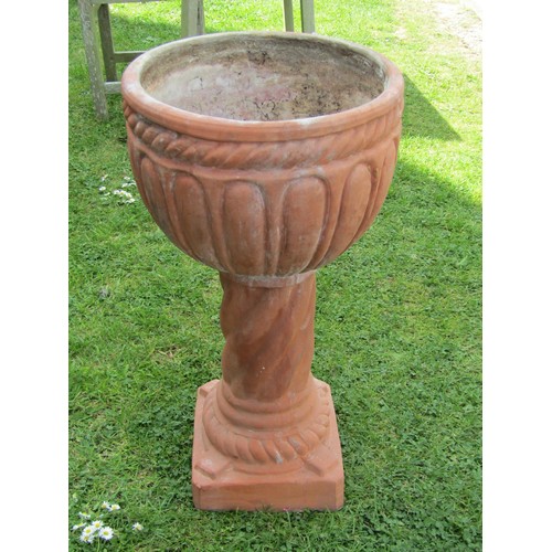 1204 - A weathered contemporary terracotta planter with circular bowl raised on a cylindrical pedestal and ... 