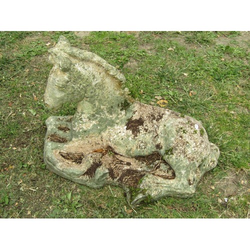 1205 - A weathered cast composition stone garden ornament in the form of a recumbent horse/foal 42 cm high ... 