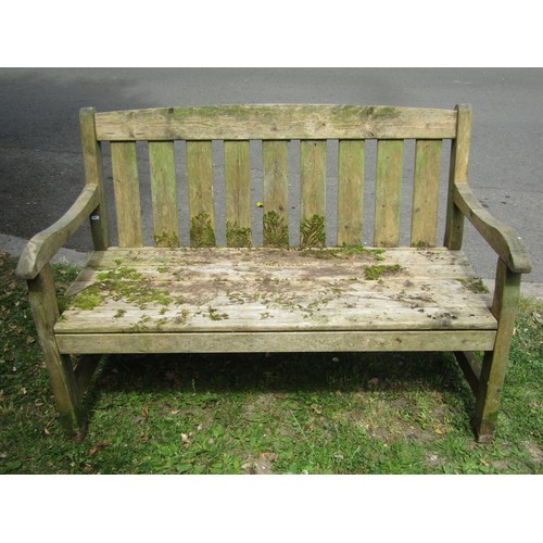 1211 - A weathered soft wood two seat garden bench with slatted seat and back, 130 cm long