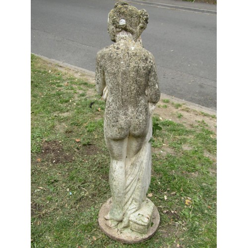 1212 - A weathered cast composition stone garden ornament in the form of a standing scantily clad classical... 