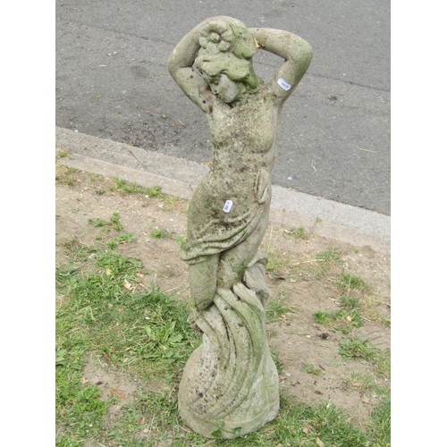 1213 - A weathered cast composition stone garden ornament in the form of a scantily clad  maiden 87 cm high