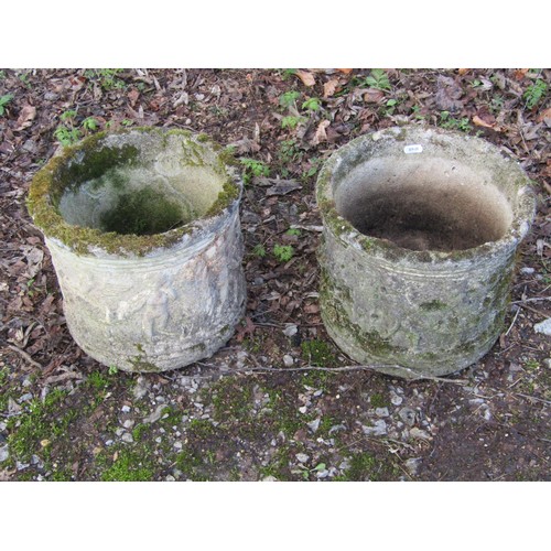 1199 - A pair of weathered cast composition stone squat cylindrical planters with repeating classical winge... 