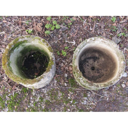 1199 - A pair of weathered cast composition stone squat cylindrical planters with repeating classical winge... 