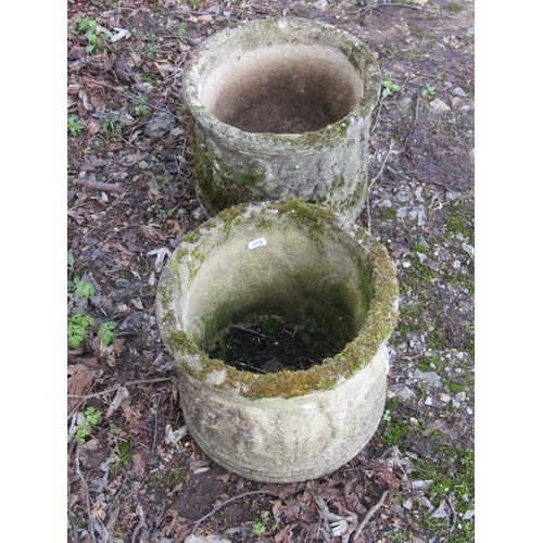 1199 - A pair of weathered cast composition stone squat cylindrical planters with repeating classical winge... 