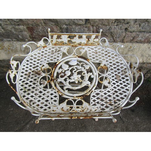 1203 - A small decorative folding garden/ conservatory table with lattice and scrolling foliate detail, 65c... 