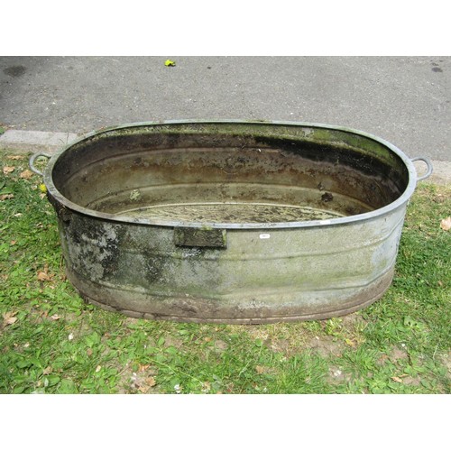 1229 - A vintage oval galvanised tin bath with simple flared rim and banded detail, 34 cm high x 103 cm x 6... 