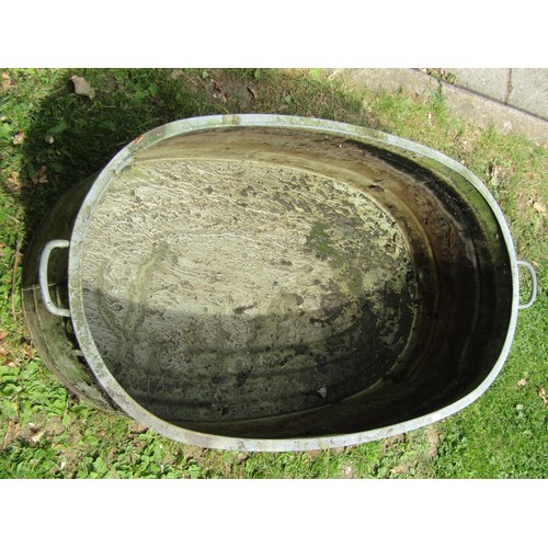 1229 - A vintage oval galvanised tin bath with simple flared rim and banded detail, 34 cm high x 103 cm x 6... 