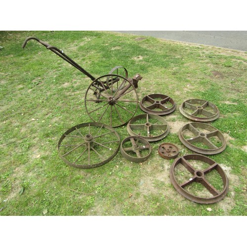 1241 - A Collection of vintage cast iron agricultural implement and further wheels together with a push hoe... 