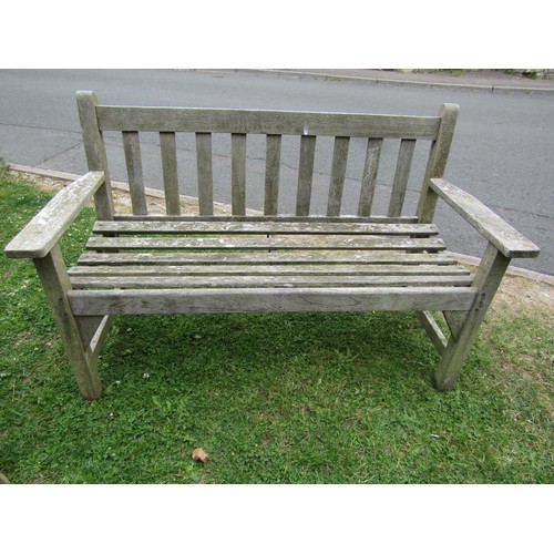 1245 - A vintage weathered teak two seat garden bench with slatted seat and back (probably a Lister example... 