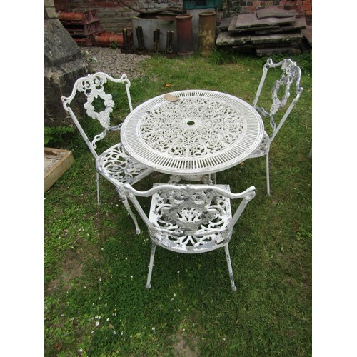 1247 - A painted and weathered cast aluminium garden terrace table of circular form with decorative pierced... 