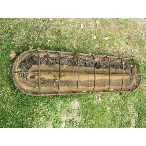 1249 - A vintage cast iron cigar shaped pig trough with open rung and central division, 122 cm (4ft long) x... 