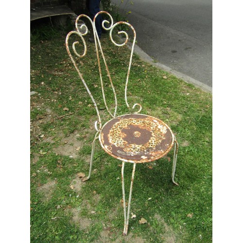 1256 - A weathered iron work four piece garden terrace set with decorative open scrollwork and pierced deta... 