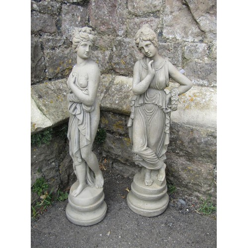 1273 - Two small weathered cast composition stone garden ornaments in the form of classical maidens in vary... 