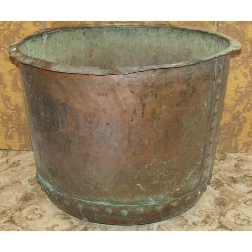 1283 - A large antique copper cauldron with flared rim and pot riveted seams, 58 cm high x 78 cm diameter