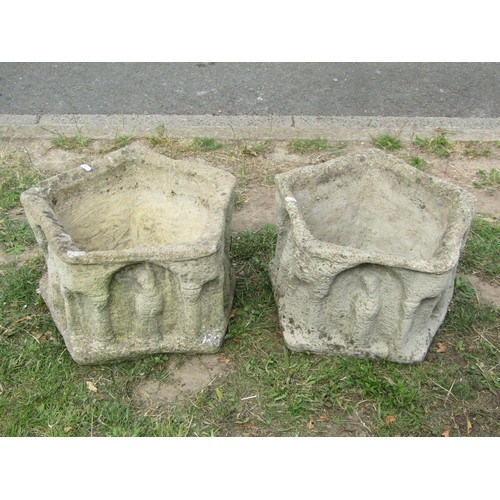 1252 - A pair of weathered mediaeval style planters of pentagonal form with repeating arcaded and figural d... 