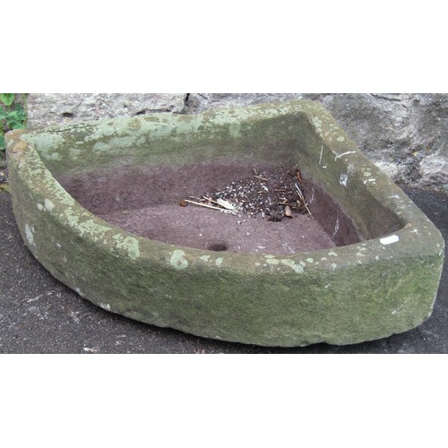 1292 - A weathered carved natural stone bow fronted corner trough with central circular drainage hole, 16 c... 