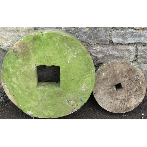 1282 - Two small carved and weathered natural stone mill wheels 40 cm and 25 cm diameter