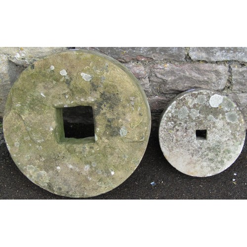 1282 - Two small carved and weathered natural stone mill wheels 40 cm and 25 cm diameter