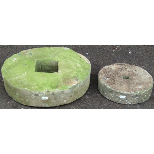 1282 - Two small carved and weathered natural stone mill wheels 40 cm and 25 cm diameter