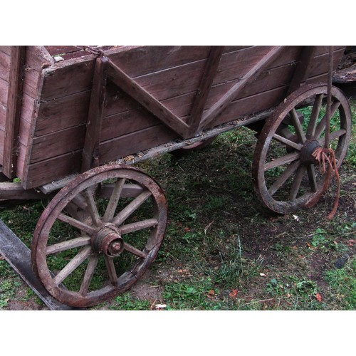 1264 - An old agricultural hand cart with boarded wooden body, chamfered spoke wheels, iron rims and fittin... 