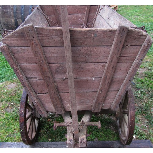 1264 - An old agricultural hand cart with boarded wooden body, chamfered spoke wheels, iron rims and fittin... 