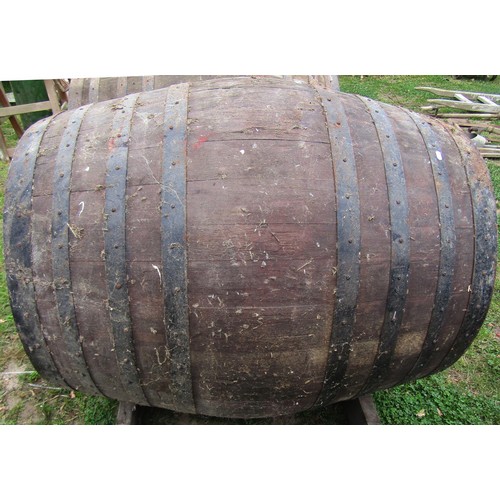 1263 - A large coopered oak and steel banded barrel adapted as a dog kennel, the barrel dimensions 123 cm (... 