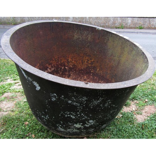 1260 - An old cast iron cauldron with flared rim and later drilled rounded base 56 cm high x 71 cm diameter