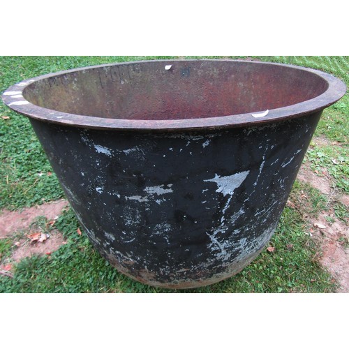 1260 - An old cast iron cauldron with flared rim and later drilled rounded base 56 cm high x 71 cm diameter