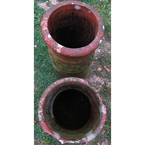 1210 - A weathered terracotta chimney/forcing pot of cylindrical tapering form 63 cm high together with a f... 