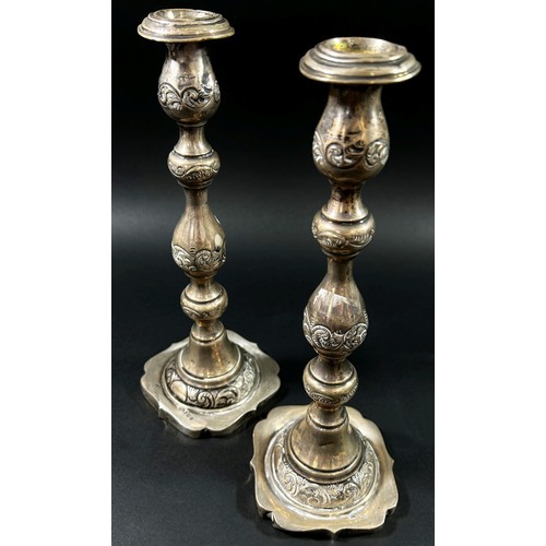 191 - A Pair of silver candlesticks in a scrolled vine design, London, 1925, makers mark rubbed, 28cm high... 